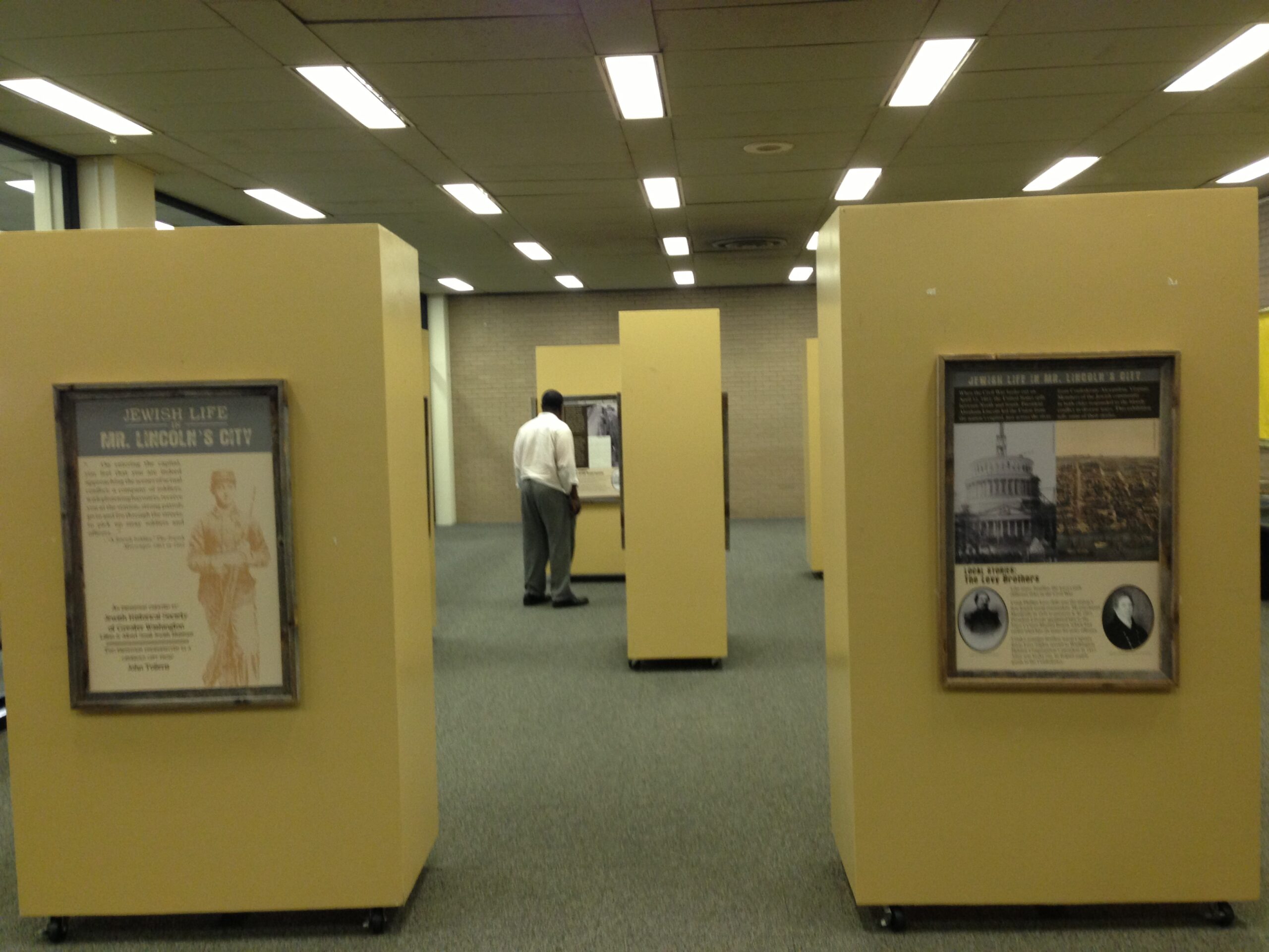 A poster exhibition mounted on several portable walls.